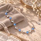 Bracelet ouvert montrant les cœurs, pierres bleues, fermoir et chaîne de rallonge