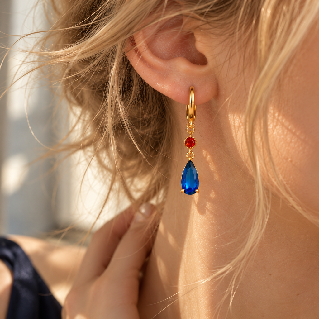 Boucle d’oreille dorée bleue et rouge portée